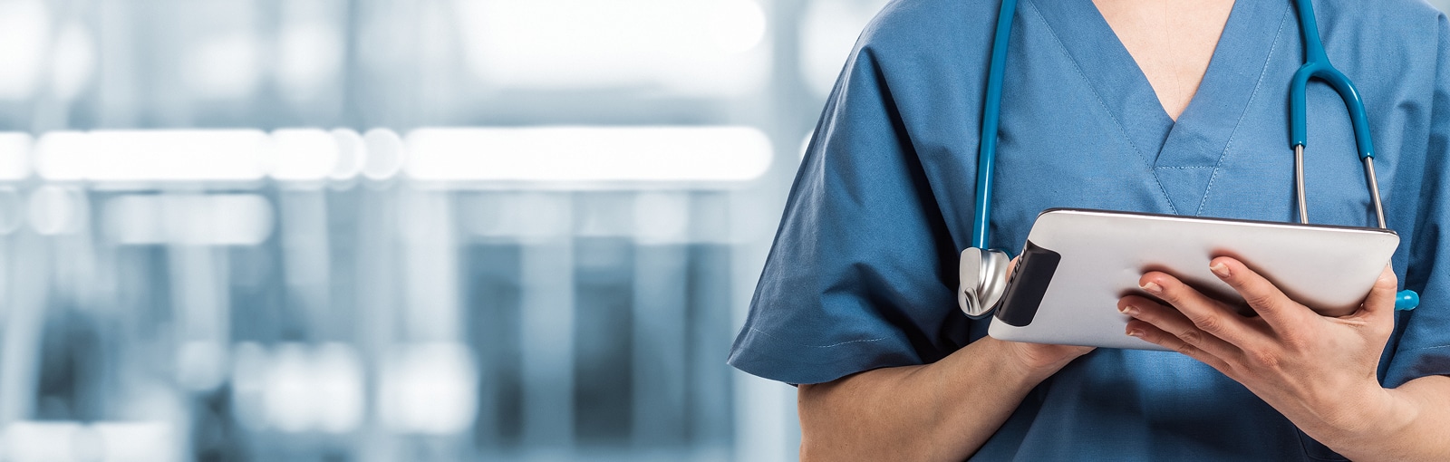 Body of a nurse writing in a tablet